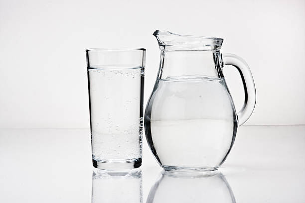 istock A large glass and a pitcher of ice water 96364549