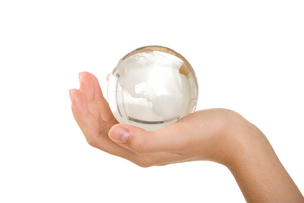 istock A transparent crystal globe being held by a person 96365995