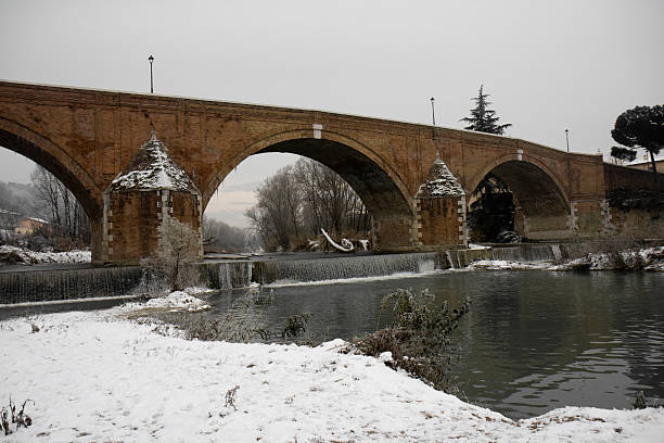 Old bridge under a snowy sky stock photo