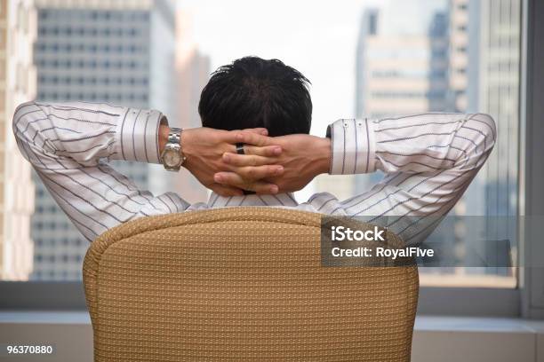 A Brunette Man Sitting Back Pleased With Himself Stock Photo - Download Image Now - Back Of Head, Men, Business