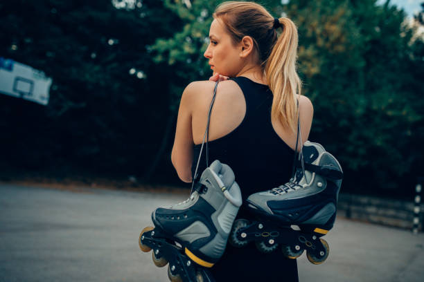 istock Woman inline skates outdoors on a sunny day 963711568