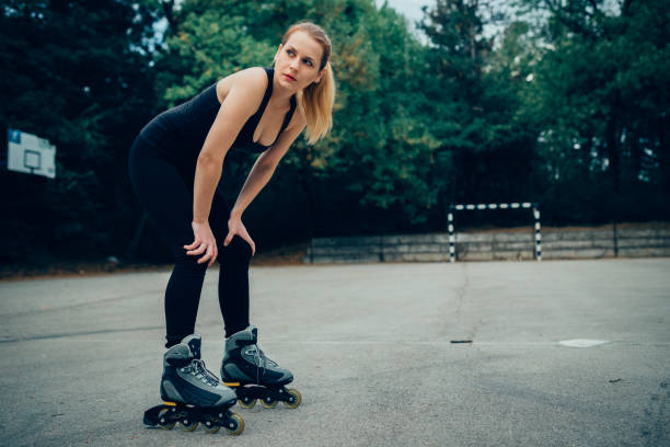 istock Beautiful woman resting after an exercise with inline skates 963711628