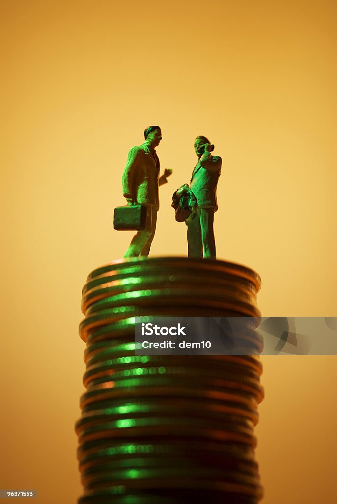 Businessman on the stack of coins  Love of Money Stock Photo