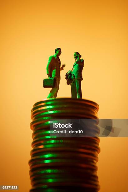 Businessman On The Stack Of Coins Stock Photo - Download Image Now - Love of Money, Achievement, Bank Account