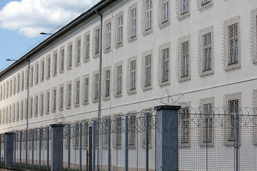Prison building with razor wire fence
