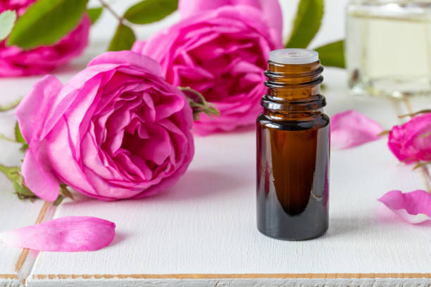 istock A bottle of rose essential oil with fresh roses 963801402