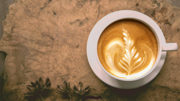 istock A cup of hot coffee ,latte art on wood table 963801870