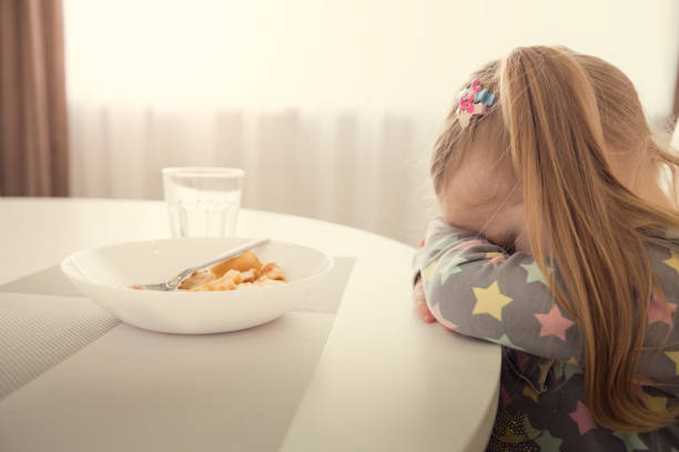 istock Girl refuses to eat. Child meal difficultes theme. 963815104