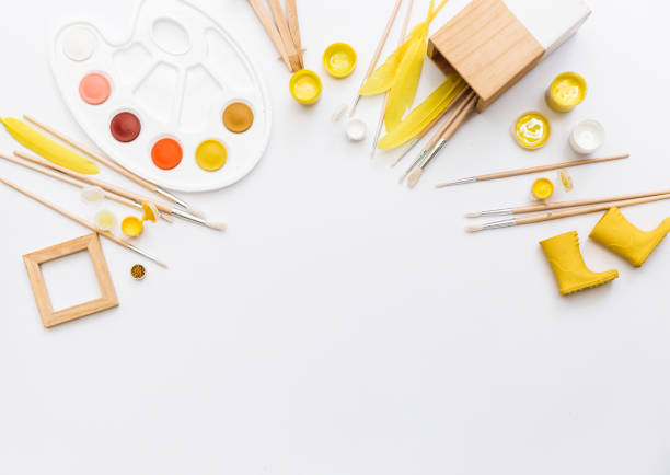 istock Artistic workspace with watercolor, paintbrush, palette, tools on white background. Flat lay, top view 963831168