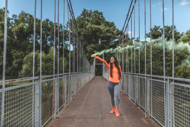 istock Modern athletic woman with smoke bomb 963831320