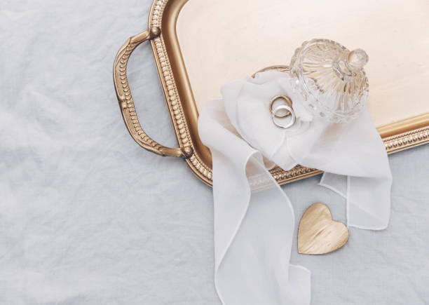 Wedding rings on gold tray, top view