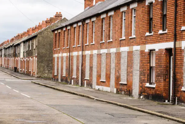 Bricked up and abandoned town houses in a run-down inner city street in Belfast