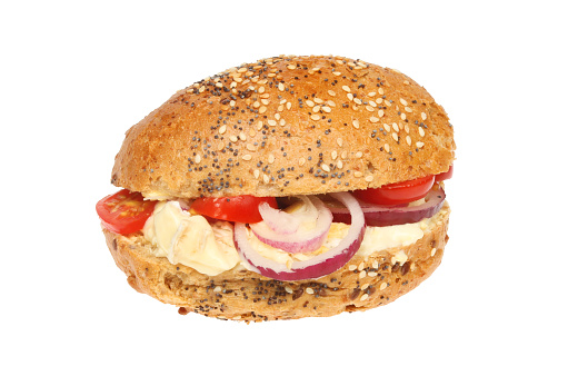 Brie, tomato and red onion in a seeded wholemeal roll isolated against white