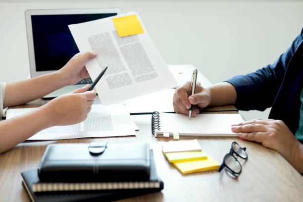 istock Two high school students campus or classmates with helps friend studying for a test an exam in workbook learning in classroom, Tutor books with friends, Education school concept 963834884