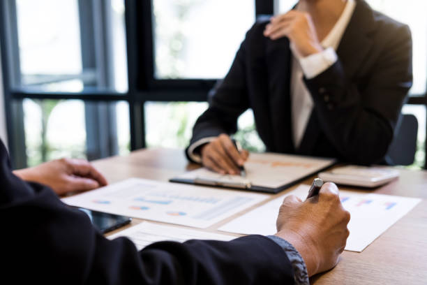 istock Two businessmen at work, Business crew working with new startup financial project plan,man and woman discussion information with laptop and digital tablet in a modern business lounge,Selective Focus 963834910