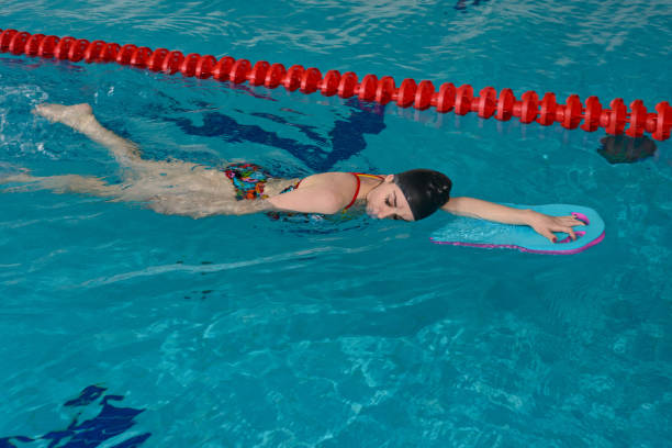 istock The girl in the water with a supporting Board 963838156