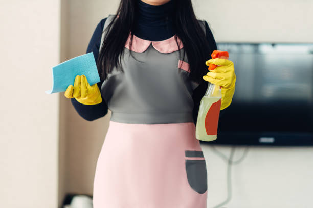 istock Female cleaner holds cleaning equipment in hands 963842768