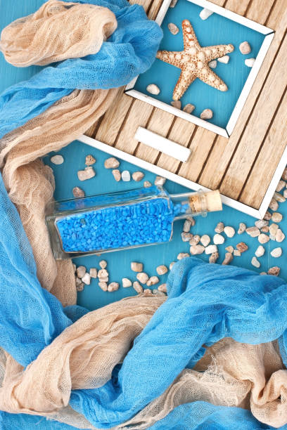 istock Sea shells and glass bottle with salt stones 963842786