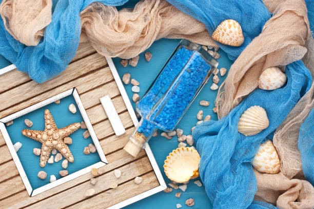 istock Sea shells and glass bottle with salt stones 963842856