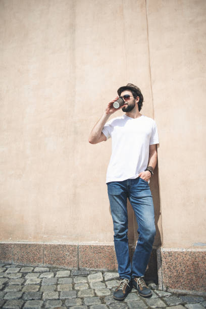 istock Stylish man drinking beverage out of doors 963845178