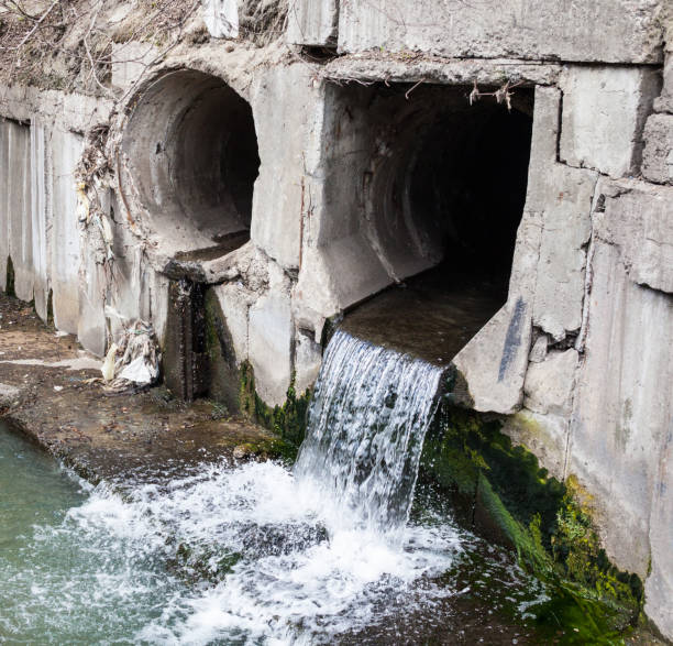 istock Run-off pipes discharging water 963845426