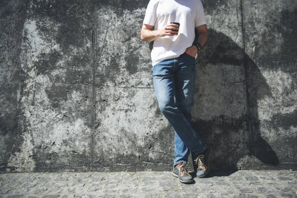 Man in casual clothes drinking hot beverage outdoors
