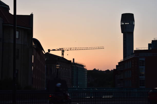 Silhouettes of construction cranes at the construction site in Slussen in central Stockholm on a spring evening.