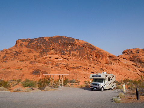 An RV motor home is parked at a campsite in the desert of Valley of Fire State Park (Nevada, USA)