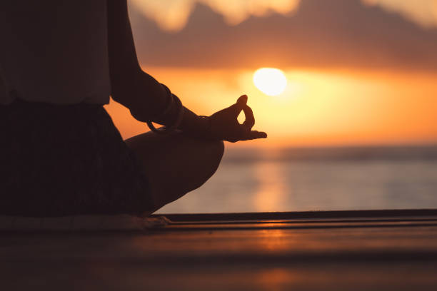 young woman practicing yoga on the beach. - sky human hand water white imagens e fotografias de stock