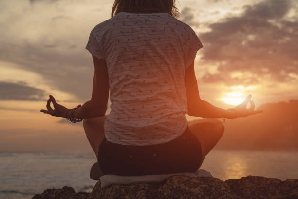 istock Young woman practicing yoga on the beach. 963864862