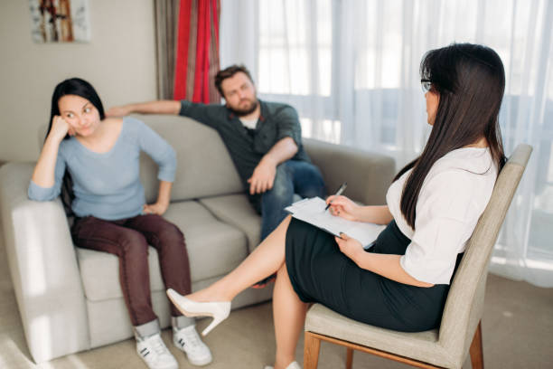 istock Sad couple swears at psychologist reception 963865570