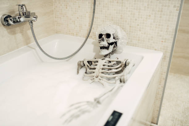 istock Scary human skeleton lying in the bathtub, humor 963865914