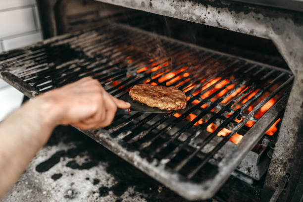 istock Cook hands prepares smoky meat on grill oven 963866054