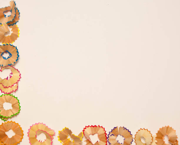 istock Color pencils shavings on white background 963868500