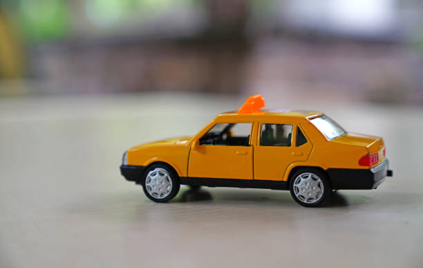 istock Yellow old taxi car on road on blurred background 963868912