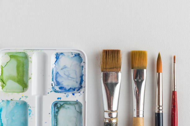 istock Box of watercolor paints and brushes 963890268