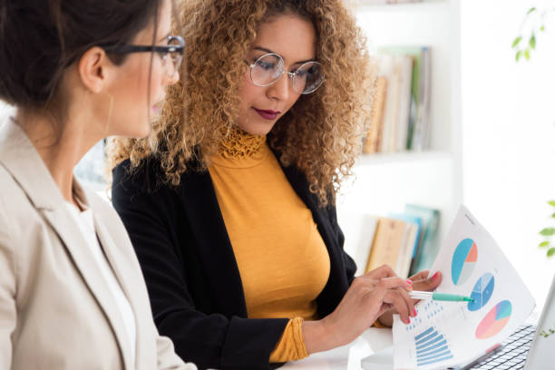 istock Two businesswoman working in her office. 963893362