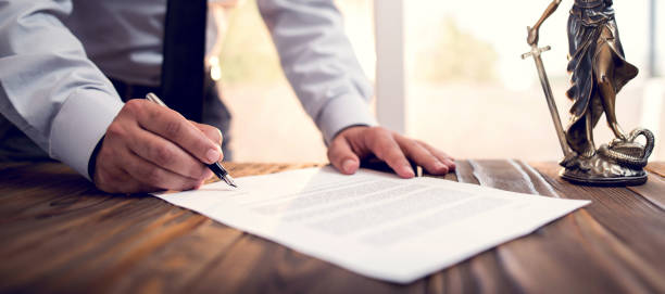 Businessman Signing An Official Document Businessman Signing An Official Document will legal document photos stock pictures, royalty-free photos & images
