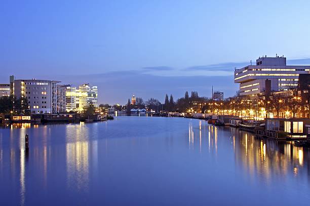 istock Amsterdam at twilight with the river Amstel in Netherlands 96389989