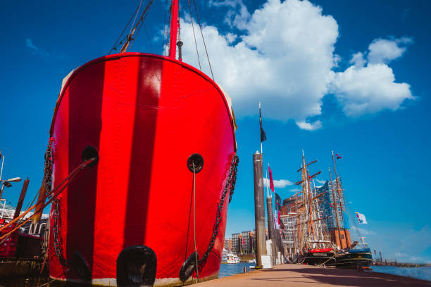 Red fire patrol boat in the port of Hamburg with a restaurant on the board HAMBURG, GERMANY - May 9, 2018: Red fire patrol boat in the port of Hamburg with a restaurant on the board. övelgönne stock pictures, royalty-free photos & images