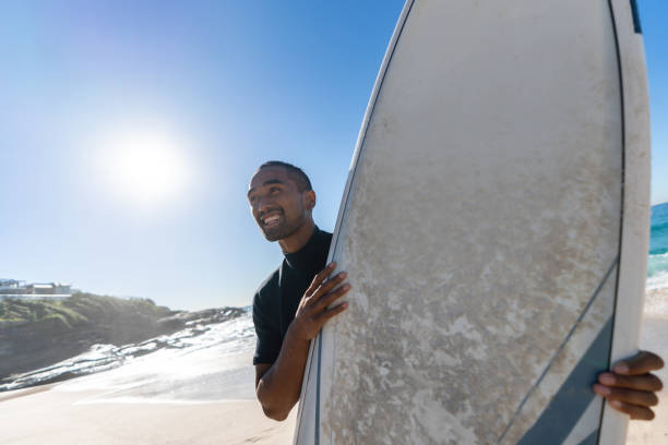 istock Male surfer at the beach looking very happy 963911464