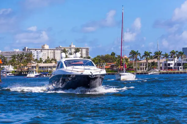 Blue and White Yacht Motoring the Intracoastal Waterway in Fort Lauderdale