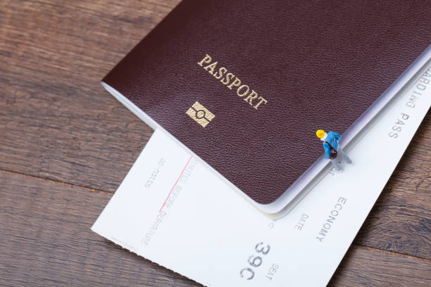 istock miniature people with passport and ticket 963919718