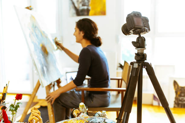 istock Beautiful female artist recording her video tutorial 963929562