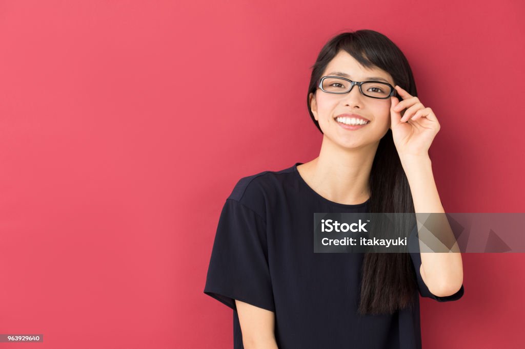 portrait of young asian woman isolated on red background Japanese Ethnicity Stock Photo