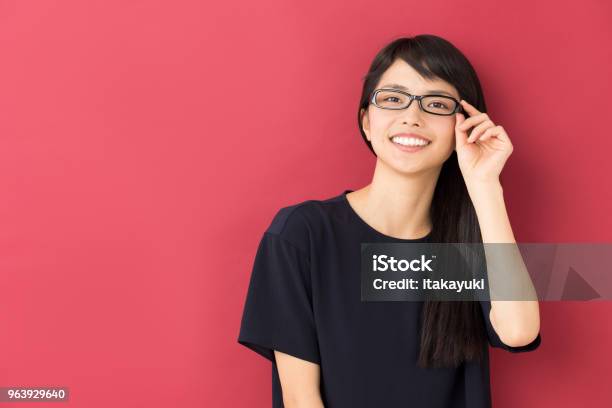 Portrait Of Young Asian Woman Isolated On Red Background Stock Photo - Download Image Now