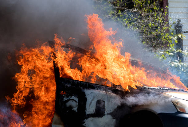 Burning Car A closeup view of a burning car. Fire rages out the windows. Dark smoke from the flames. sabotage photos stock pictures, royalty-free photos & images