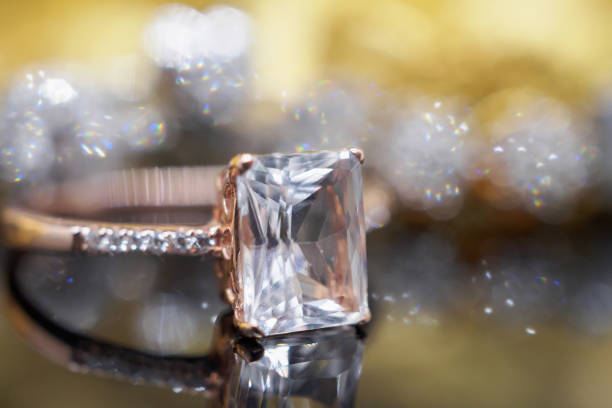 istock Luxury Jewelry diamond and pink topaz ring with reflection on black background 963939240