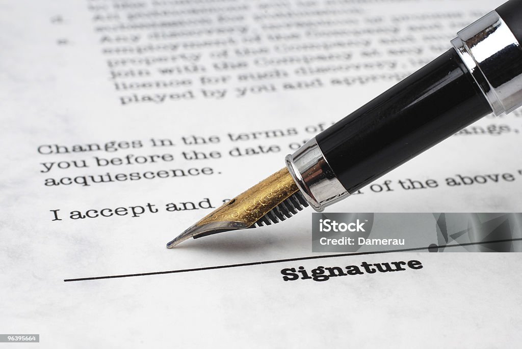 Stock image of a fountain pen about to sign a signature line Fountain pen that is just about to sign a contract. Agreement Stock Photo