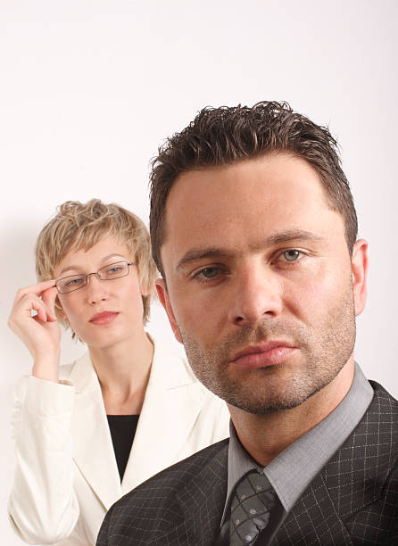 Successful, proud and happy business people standing on white background. Businesswoman and businessman. With suit. Two people.